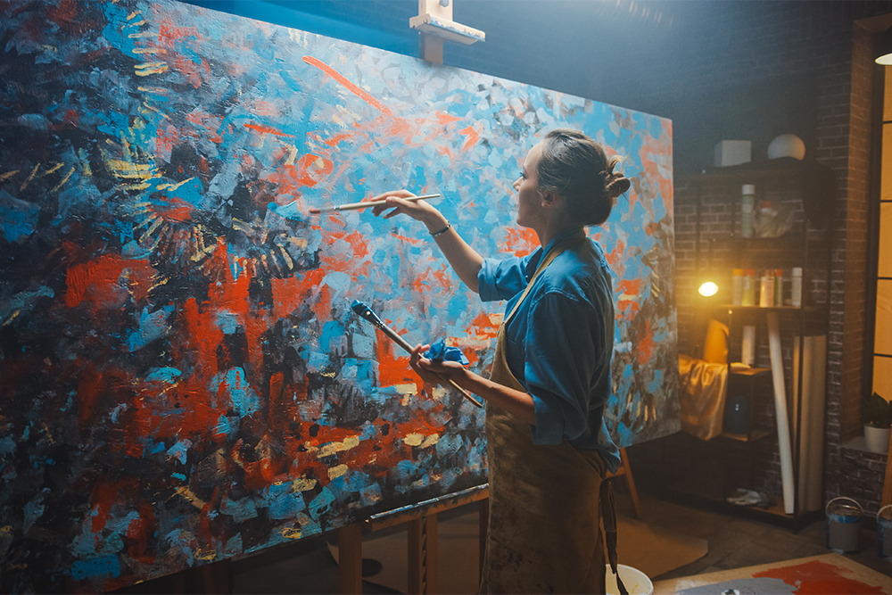 https://www.artsupplies.co.uk/blog/wp-content/uploads/2020/07/Female-Artist-Works-on-Abstract-Oil-Painting-Using-Paint-Brush-She-Creates-Modern-Masterpiece.jpg