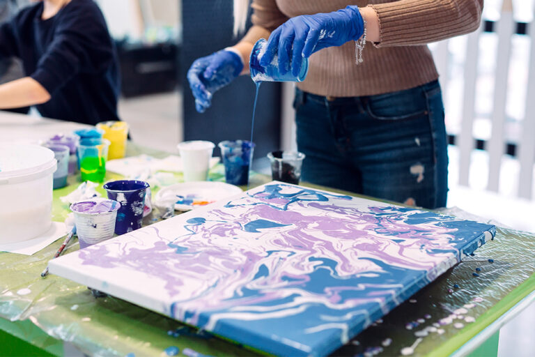 9 Basic And Advanced Acrylic Pouring Techniques To Try Today Bromleys   Artist Acrylic Pour Painting On A Traditional Stretched Canvas 768x512 